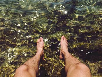 Man dipping feet in river