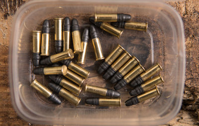 Directly above shot of bullets in container on table