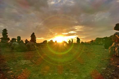 Panoramic shot of field against sky during sunset