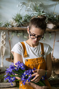 Florist holding flowers in shop