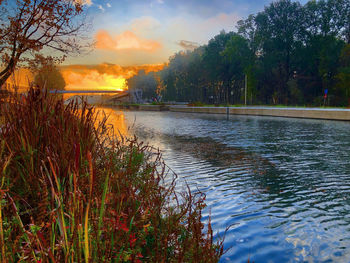 Scenic view of lake against sky at sunset