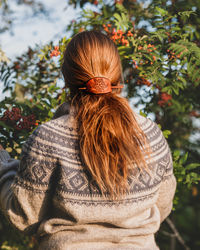 Rear view of woman with plants