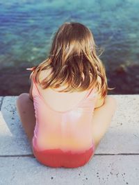 Rear view of woman sitting outdoors