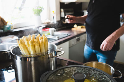 Midsection of man preparing food in kitchen