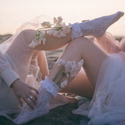 Midsection of bride holding bouquet