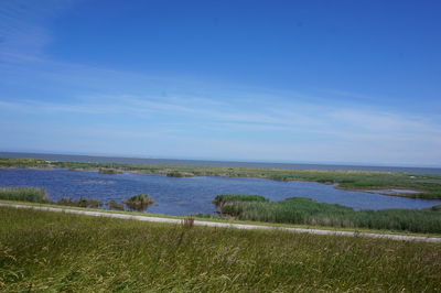 Scenic view of land against blue sky