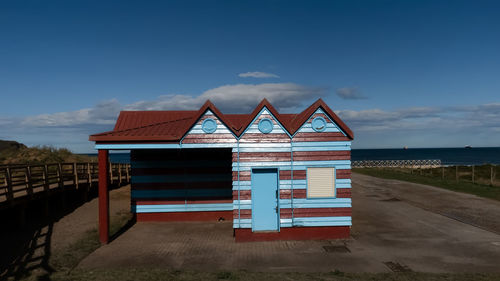 Beach hut against sky