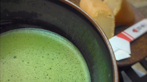 Close-up of matcha tea in container