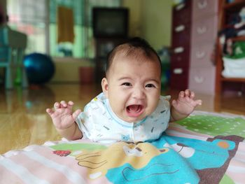 Portrait of cute baby crying at home