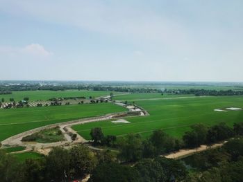 High angle view of green landscape against sky