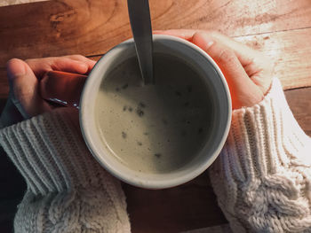 Close-up of hand holding tea cup