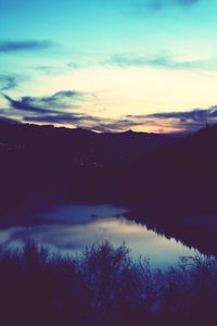 Scenic view of silhouette mountains against sky at sunset