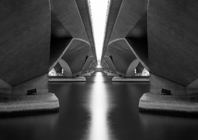 Low angle view of bridge over river at night