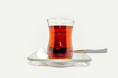 Close-up of beer glass against white background