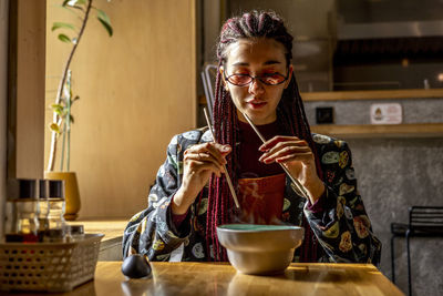 Woman eating food in restaurant