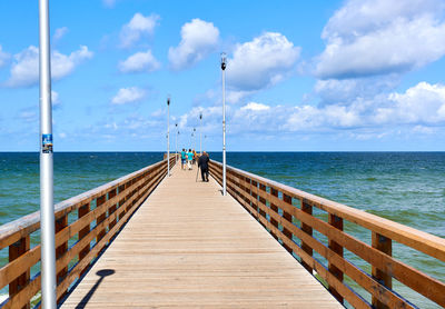 Pier over sea against sky