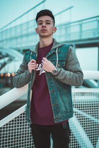 Full length of man standing on railing in city