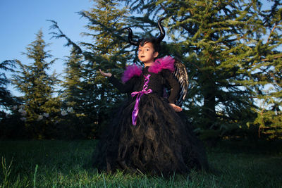 Full length of woman looking away on tree