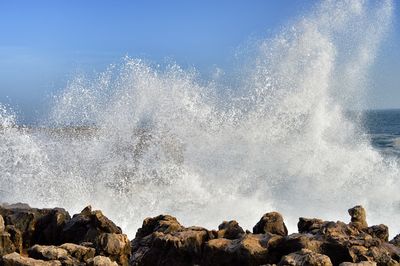 View of waves splashing on rocks