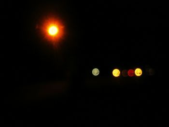 Low angle view of illuminated lights at night