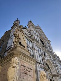 Low angle view of historic building against clear blue sky dante basilica di santa croce florence