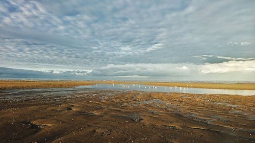 View of lake against cloudy sky