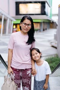 Portrait of smiling mature woman with daughter