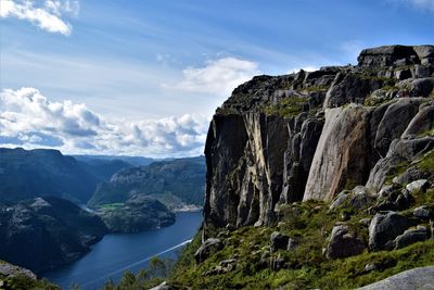 Scenic view of rocky mountains against cloudy sky
