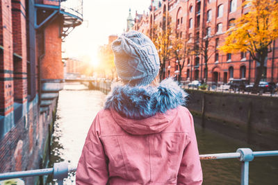 Rear view of woman in city during winter