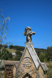 Low angle view of statue against clear blue sky