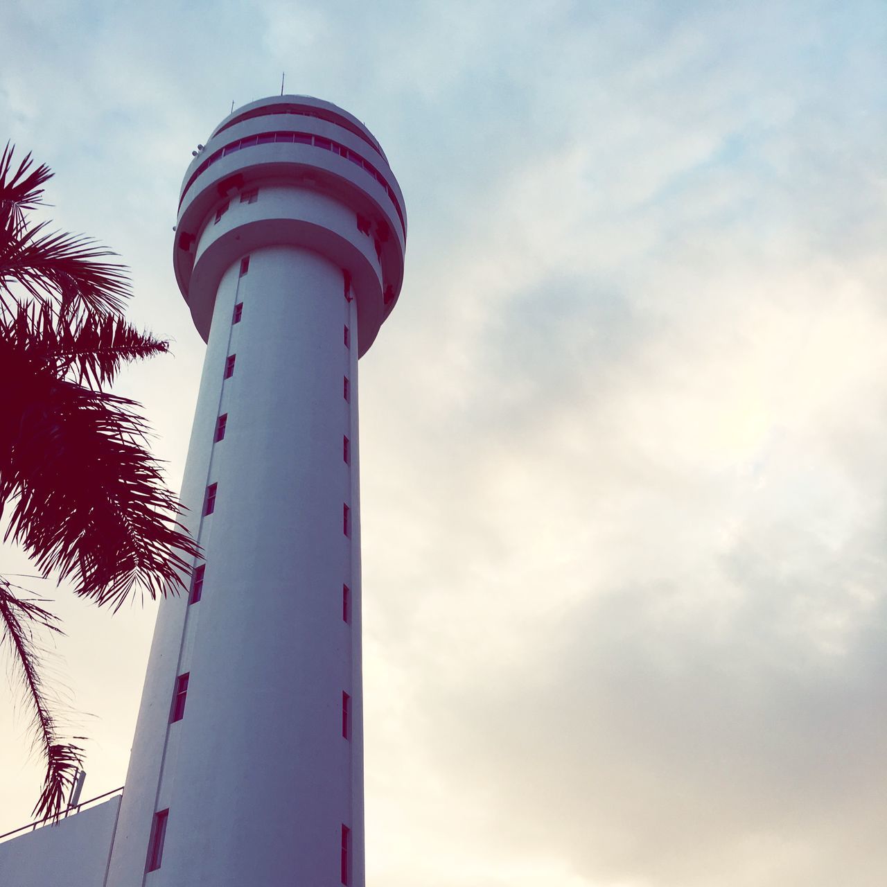 lighthouse, tower, architecture, guidance, built structure, low angle view, tall - high, direction, protection, building exterior, sky, safety, tall, cloud - sky, outdoors, day, no people, cloudy