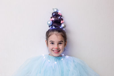 Portrait of funny girl with a hairstyle in the form of a christmas tree