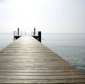 Pier over sea against clear sky