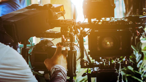 Cropped hand holding television camera