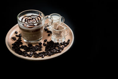 Close-up of coffee cup against black background