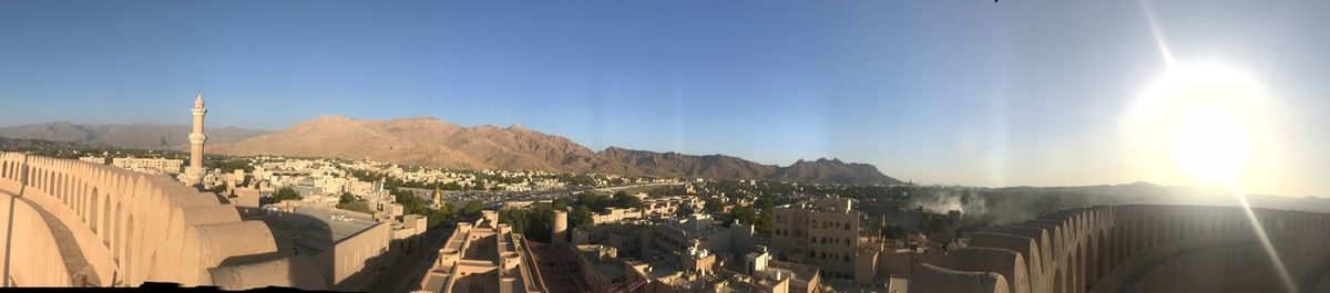 Panoramic view of buildings against blue sky