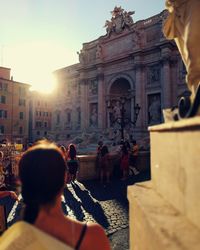 People at trevi fountain in city