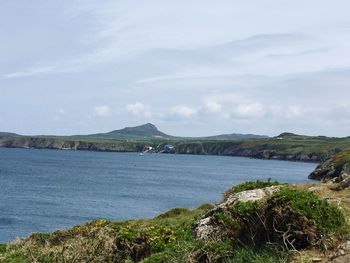 Scenic view of sea and mountains against sky