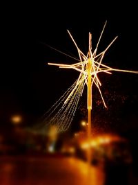 Low angle view of firework display at night