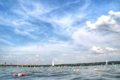 Scenic view of sea by buildings against sky