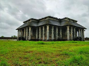 Old building on field against sky