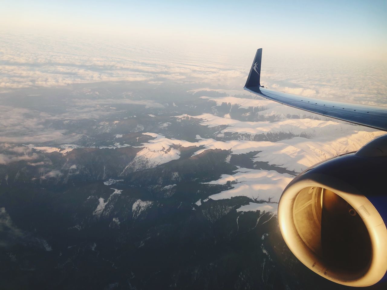 air vehicle, airplane, mode of transportation, flying, transportation, aerial view, aircraft wing, cloud - sky, sky, travel, beauty in nature, scenics - nature, engine, no people, motion, journey, mid-air, jet engine, nature, on the move, outdoors, view into land, plane