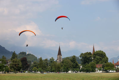 Low angle view of person paragliding against clear sky