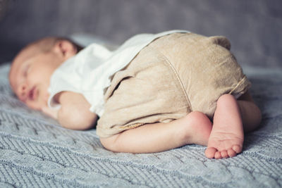 Cute boy sleeping on bed at home