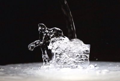 Close-up of splashing water over black background