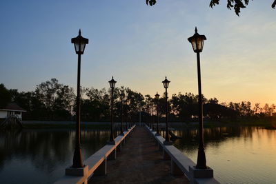 Street light by trees against sky