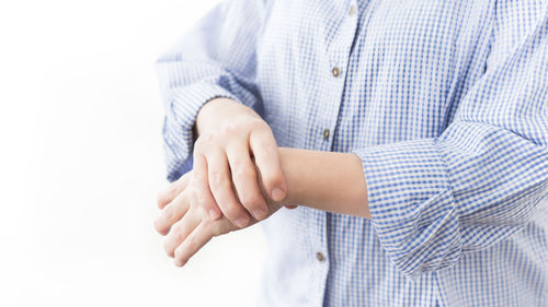 Close-up of baby hand against white background