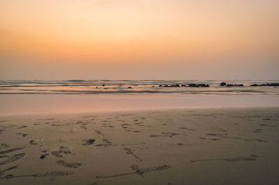 Scenic view of beach against sky during sunset