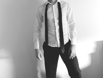 Close-up of man standing against the wall