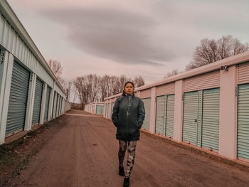 Full length portrait of man standing against sky